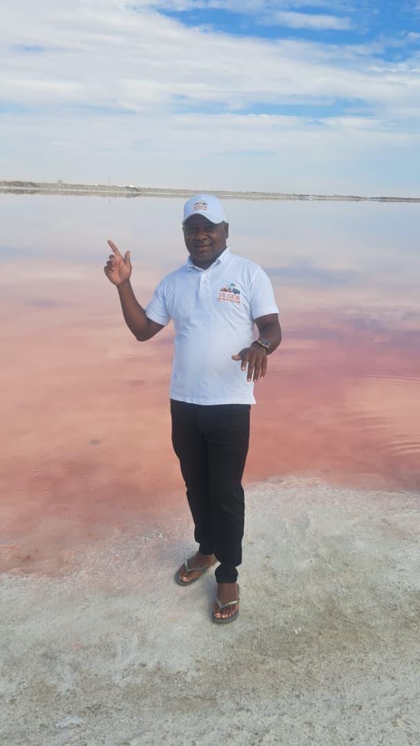 SEGEN Tours owner in branded polo shirt at the Pink Lake, Walvis Bay
