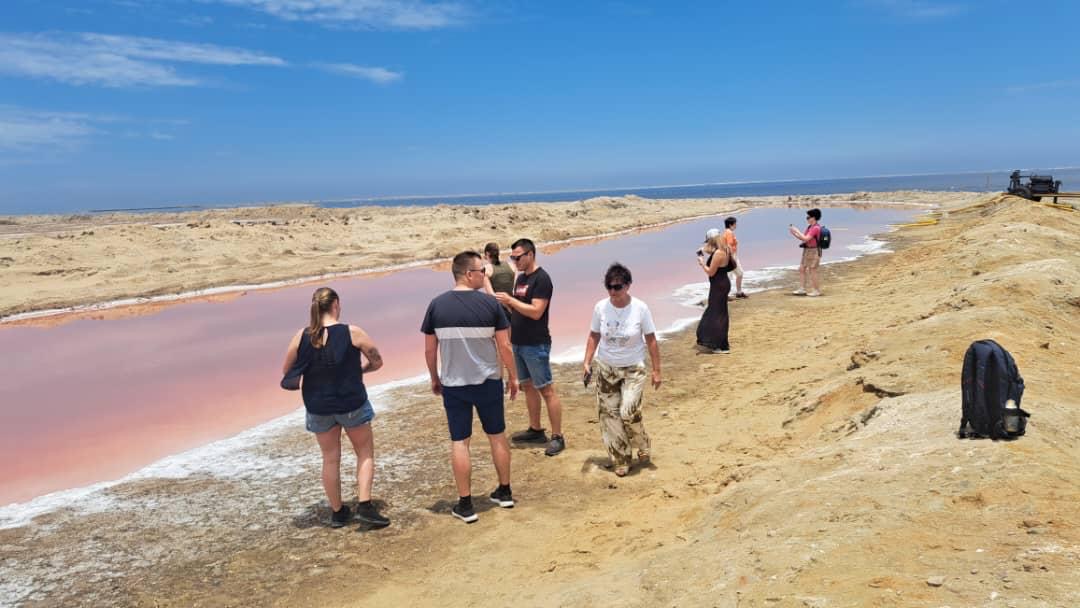 SEGEN Tours group exploring the stunning Pink Lake salt pans near Walvis Bay